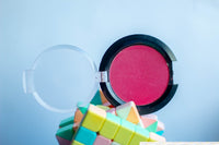 a close up of a pink powder on a pile of rubs